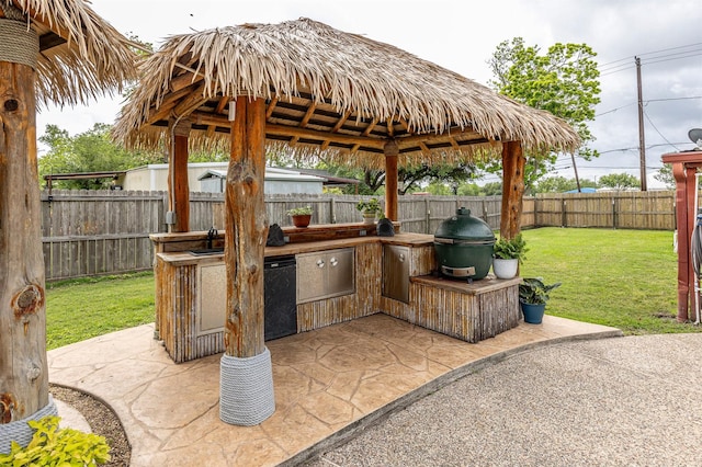 view of patio with a gazebo, grilling area, area for grilling, a fenced backyard, and a sink