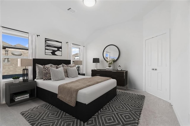 carpeted bedroom with baseboards, visible vents, and lofted ceiling
