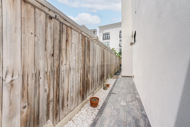 view of side of property with stucco siding and fence