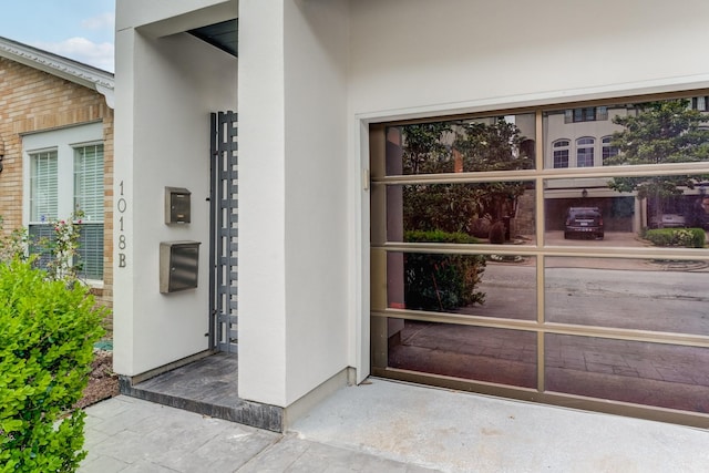 entrance to property with stucco siding