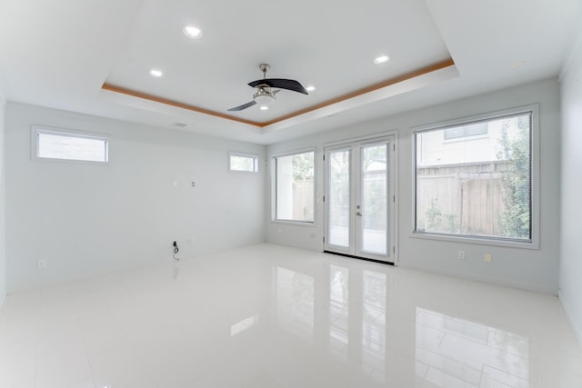 unfurnished room with a raised ceiling, ceiling fan, and recessed lighting