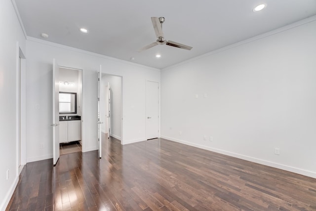 unfurnished bedroom with baseboards, ornamental molding, and dark wood-style floors
