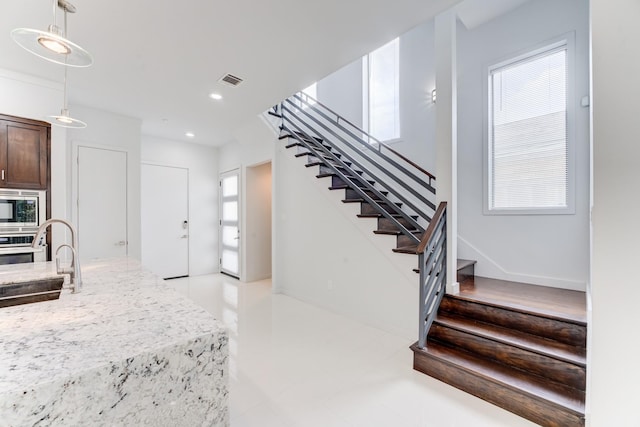 stairs featuring recessed lighting and visible vents