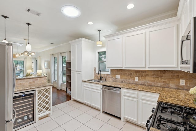 kitchen with appliances with stainless steel finishes, a sink, white cabinetry, wine cooler, and visible vents