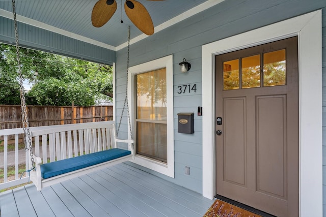 doorway to property featuring a ceiling fan and covered porch