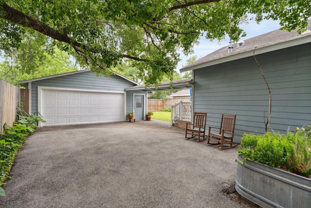 detached garage featuring fence