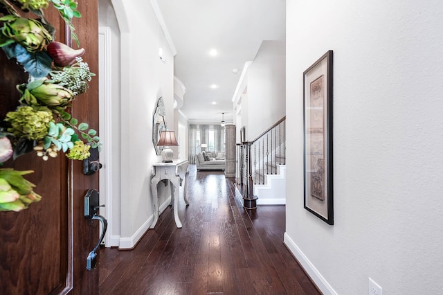 foyer with ornamental molding, stairs, wood finished floors, baseboards, and recessed lighting