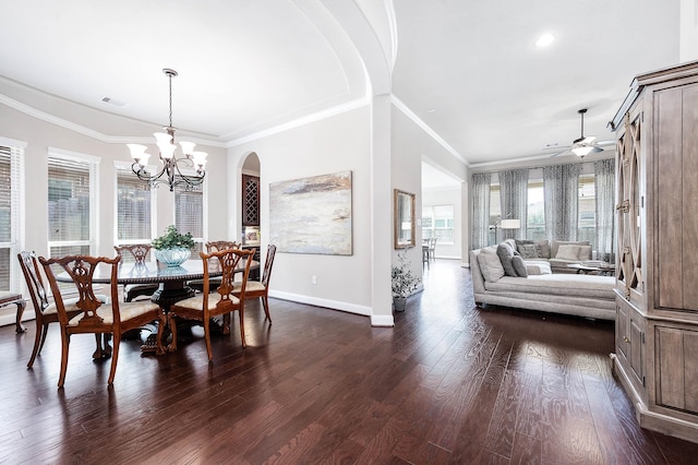 dining room with crown molding, visible vents, baseboards, dark wood finished floors, and ceiling fan with notable chandelier