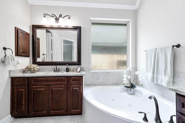 full bath featuring crown molding, vanity, and a jetted tub