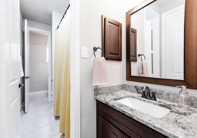 full bathroom featuring vanity and tile patterned flooring