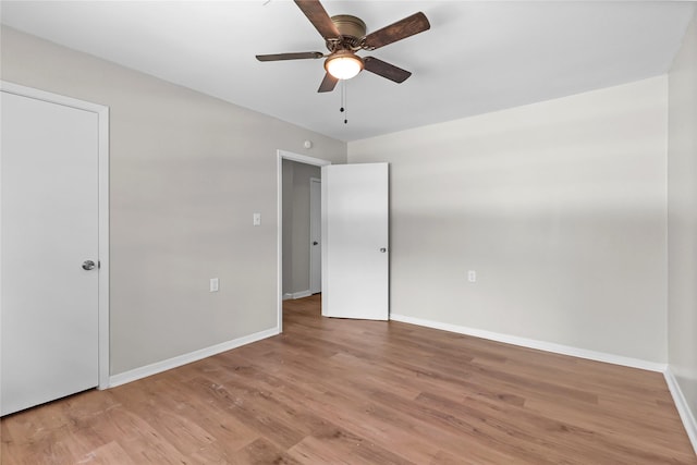 unfurnished bedroom featuring baseboards, a ceiling fan, and light wood-type flooring