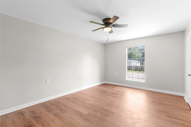 spare room with light wood-style floors, baseboards, and ceiling fan