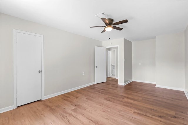 unfurnished bedroom featuring baseboards, visible vents, ceiling fan, and light wood-style floors