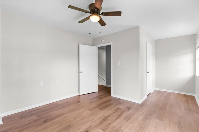 unfurnished bedroom featuring baseboards, ceiling fan, and light wood-type flooring