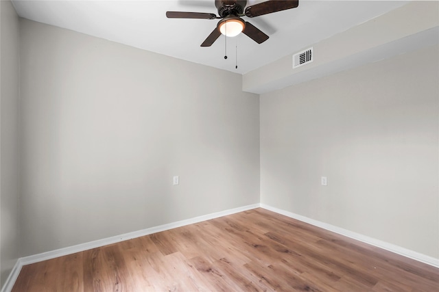 unfurnished room featuring a ceiling fan, baseboards, visible vents, and light wood-style floors