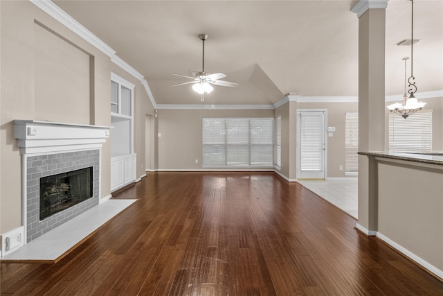 2215 Bay Haven Way, League City, TX 77573 - unfurnished living room with a ceiling fan, wood finished floors, a tile fireplace, a chandelier, and vaulted ceiling