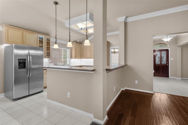 2215 Bay Haven Way, League City, TX 77573 - kitchen featuring stainless steel fridge with ice dispenser, crown molding, light brown cabinetry, glass insert cabinets, and light stone counters