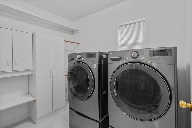 2215 Bay Haven Way, League City, TX 77573 - laundry room featuring cabinet space, washing machine and clothes dryer, and light marble finish flooring