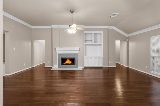 2215 Bay Haven Way, League City, TX 77573 - unfurnished living room featuring wood finished floors, ceiling fan, a tile fireplace, ornamental molding, and built in shelves