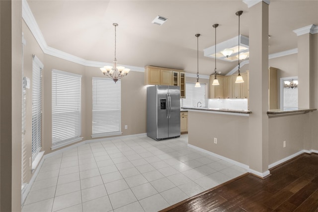 2215 Bay Haven Way, League City, TX 77573 - kitchen featuring stainless steel fridge, a chandelier, lofted ceiling, light brown cabinets, and glass insert cabinets