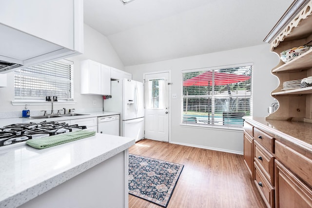 kitchen featuring open shelves, a sink, white appliances, light wood-style flooring, and vaulted ceiling