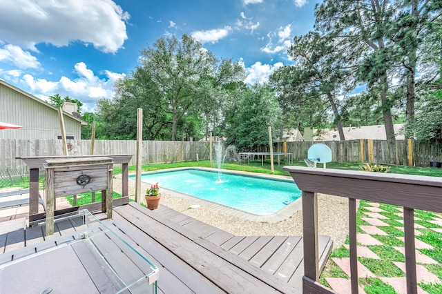 view of swimming pool with a fenced in pool, a wooden deck, and a fenced backyard