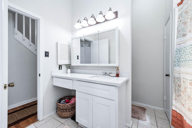bathroom featuring vanity, tile patterned flooring, and baseboards