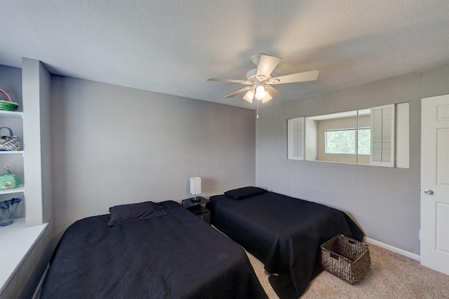 carpeted bedroom featuring a textured ceiling and ceiling fan