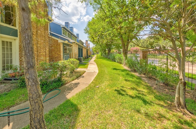 view of yard featuring fence and cooling unit