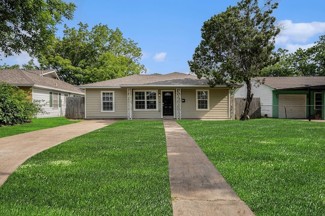 bungalow-style home with fence, driveway, and a front yard