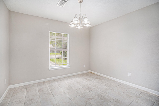 unfurnished room featuring a chandelier, baseboards, visible vents, and light tile patterned floors