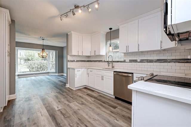 kitchen featuring backsplash, white cabinetry, a sink, and dishwasher