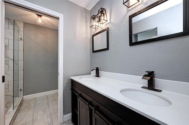 full bathroom featuring a sink, double vanity, tiled shower, and marble finish floor