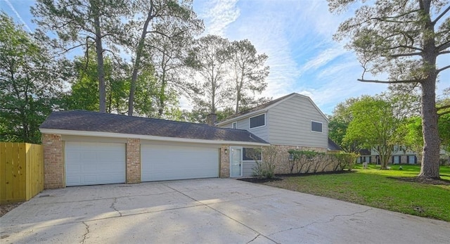view of home's exterior with fence, brick siding, a garage, concrete driveway, and a lawn