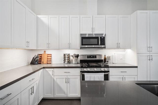1023 Roberts St, Houston, TX 77003 - kitchen featuring stainless steel appliances, backsplash, and white cabinetry