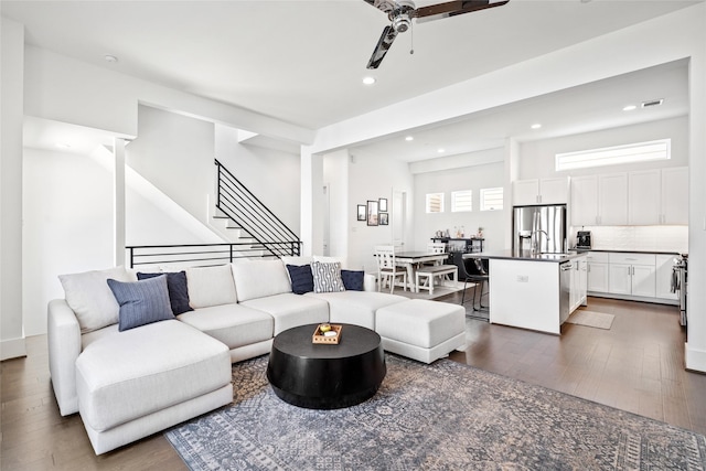 1023 Roberts St, Houston, TX 77003 - living room featuring dark wood finished floors, recessed lighting, a ceiling fan, and stairway