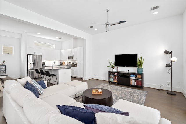 1023 Roberts St, Houston, TX 77003 - living room with a ceiling fan, recessed lighting, dark wood-style flooring, and baseboards