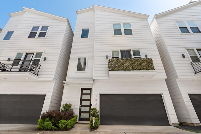 1023 Roberts St, Houston, TX 77003 - view of front of property featuring a garage, concrete driveway, and a balcony