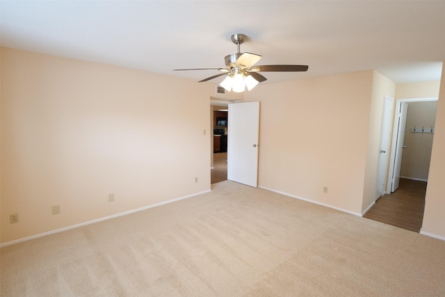 empty room featuring baseboards, ceiling fan, carpet flooring, and visible vents