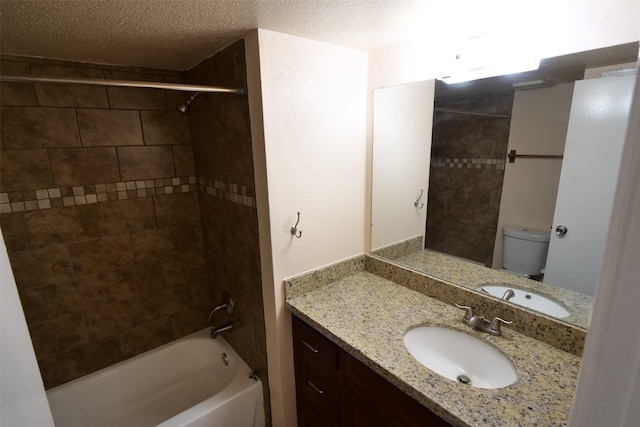 bathroom with vanity, toilet, a textured ceiling, and tub / shower combination