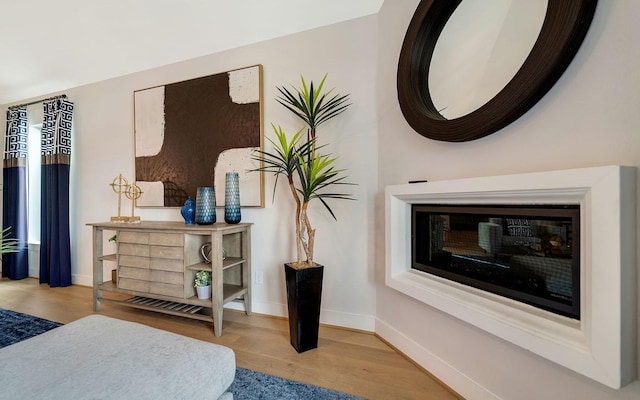 bedroom featuring baseboards and wood finished floors