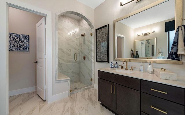 full bathroom with baseboards, a shower stall, marble finish floor, and vanity