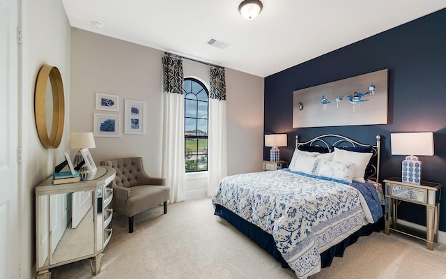 carpeted bedroom with baseboards and visible vents