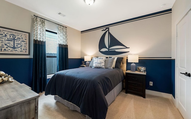 bedroom with light colored carpet and visible vents