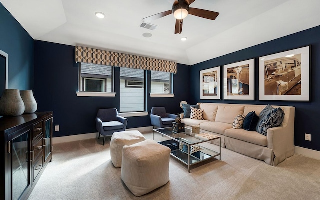 living room featuring ceiling fan, visible vents, baseboards, and carpet