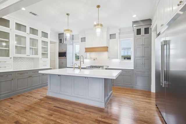 1623 Blount St, Houston, TX 77008 - kitchen with built in appliances, gray cabinetry, a sink, backsplash, and light countertops