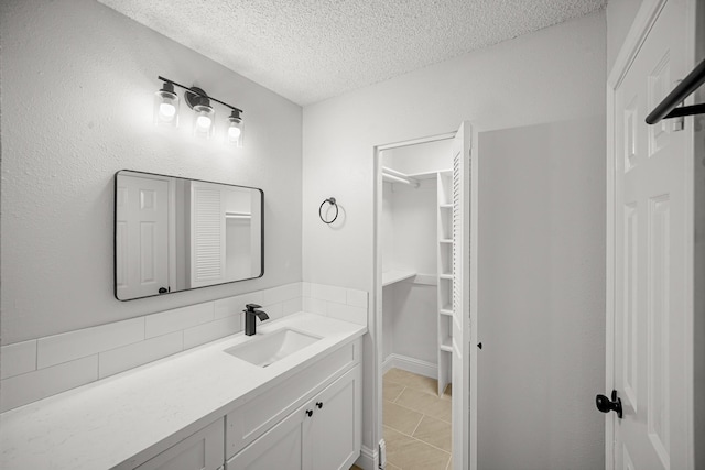 bathroom featuring vanity, a textured ceiling, and backsplash