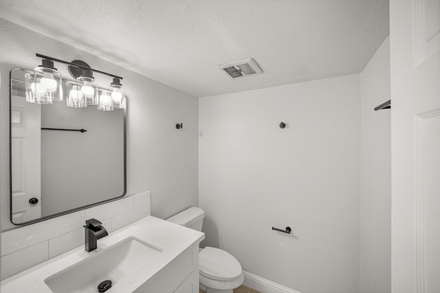 bathroom featuring vanity, toilet, a textured ceiling, tasteful backsplash, and visible vents