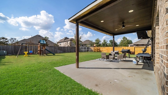 view of patio featuring a ceiling fan, a fenced backyard, and a playground