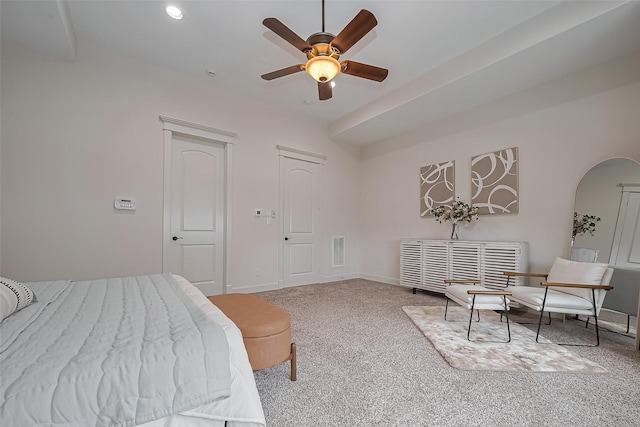 carpeted bedroom featuring baseboards, arched walkways, a ceiling fan, and visible vents